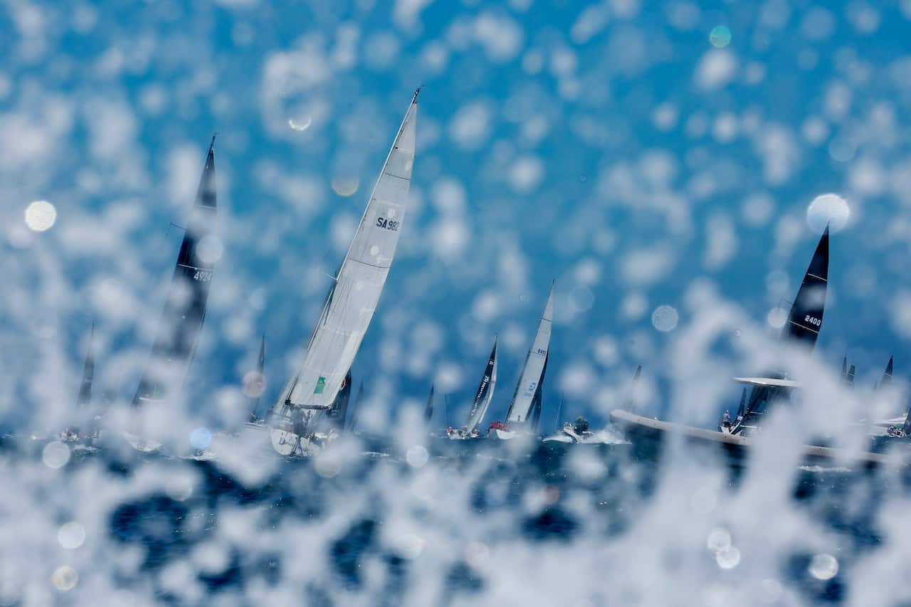 Yachts sails south out of the Sydney Heads during the 2022 Sydney to Hobart yacht race on Boxing Day.