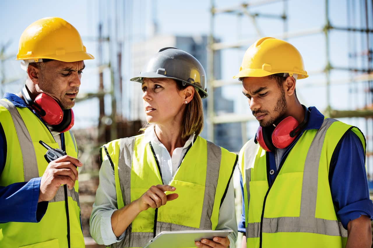 Architects using a digital tablet at a site