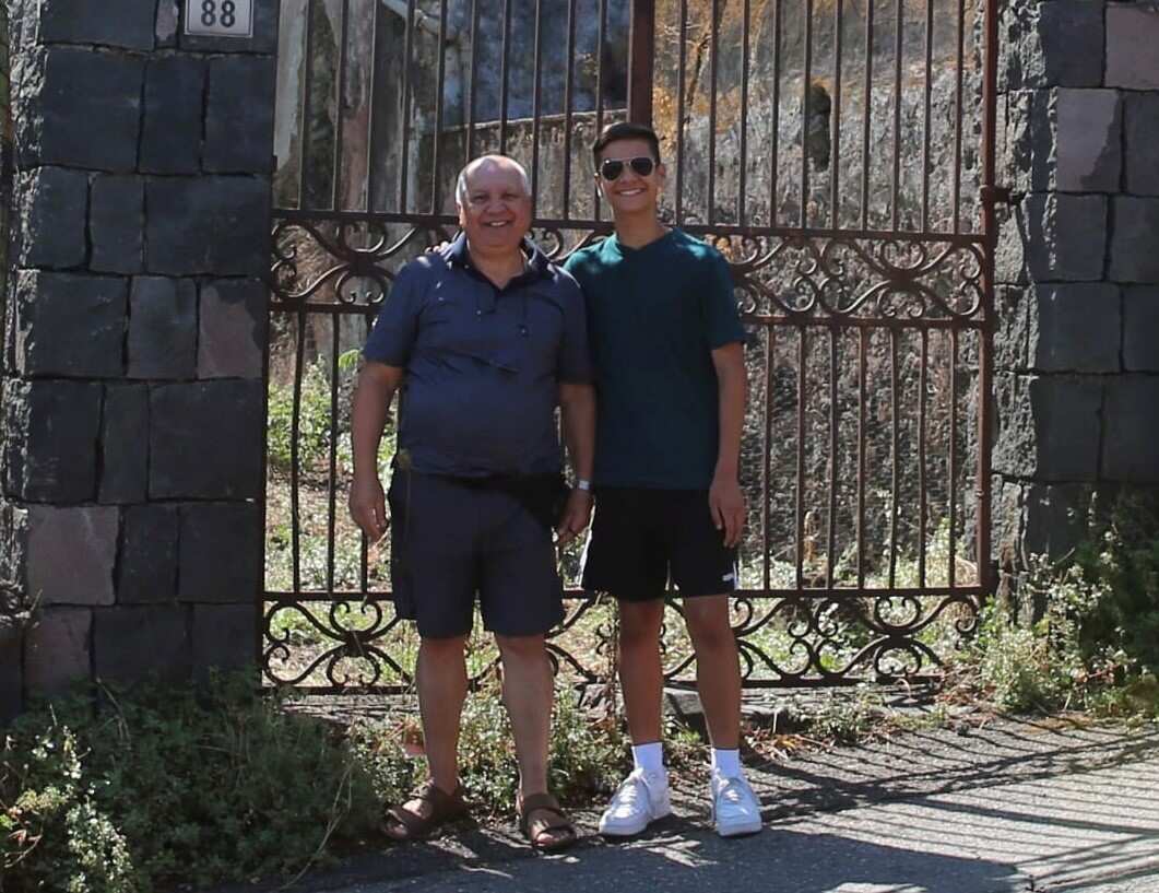 John Samperi in front of the gate of his ancestral home in Italy in 2022.
