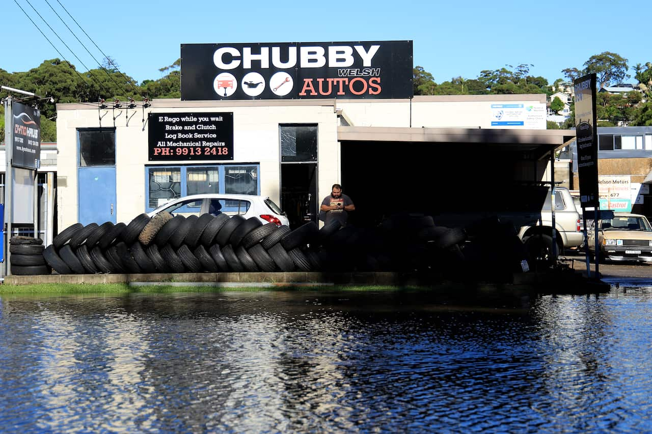 Business owners watched as river levels rose due to flooding, threatening their shopfronts.