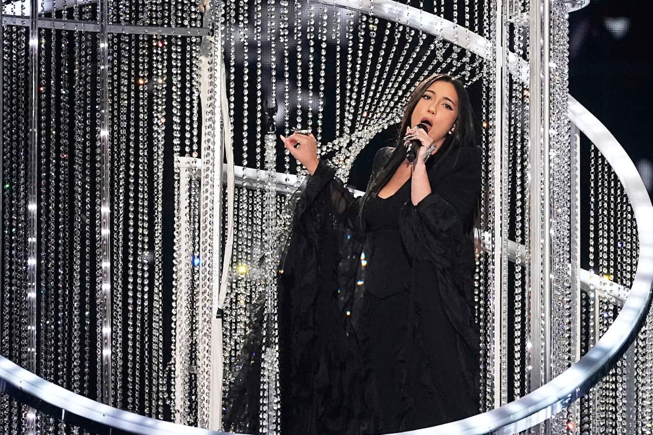 A woman wearing black performing on stage