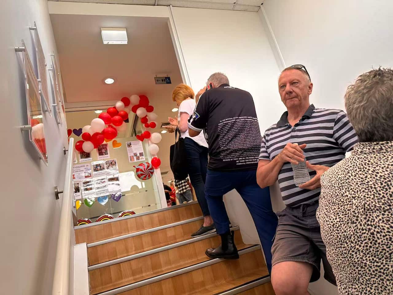 Blood donors quietly line up, waiting to donate blood.