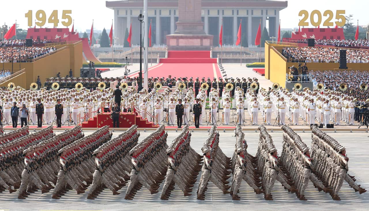 Chinese troops march in step during a parade.