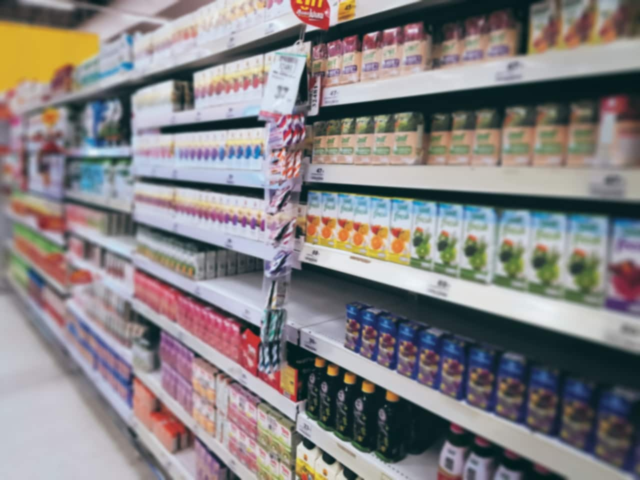 blurred-background-of-juice-boxes-on-shelves-at-gr-2024-05-27-01-06-14-utc.jpg