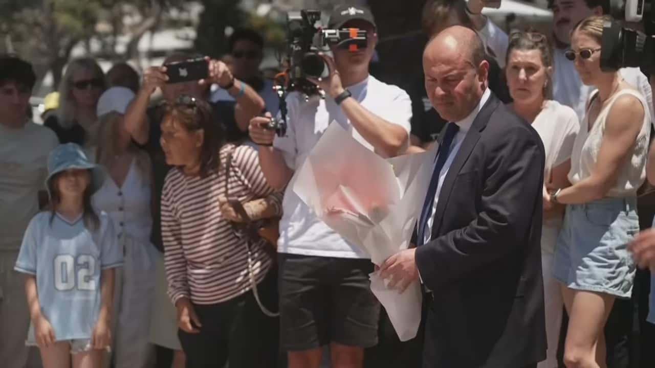 Former Liberal MP Josh Frydenberg holds flowers