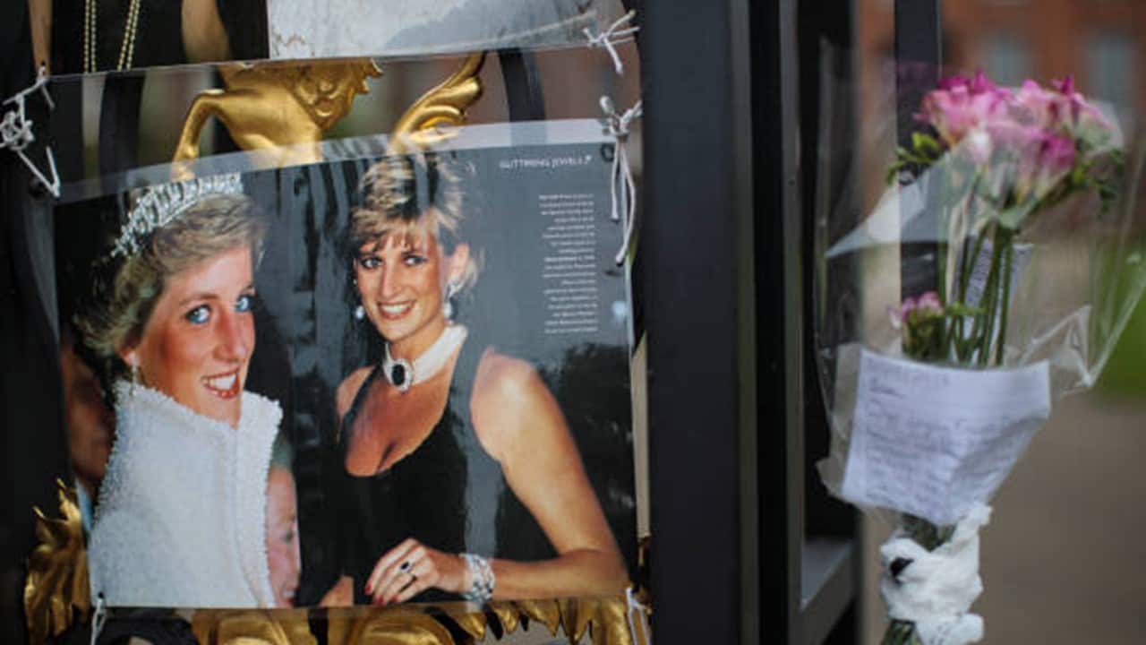 Floral tributes, photographs and messages sit on an entrance gate to Kensington Palace ahead of the 20th anniversary of the death of Diana.jpg