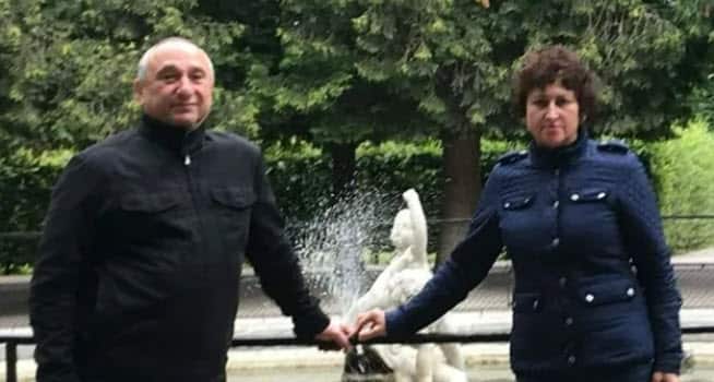 A couple holding hands.