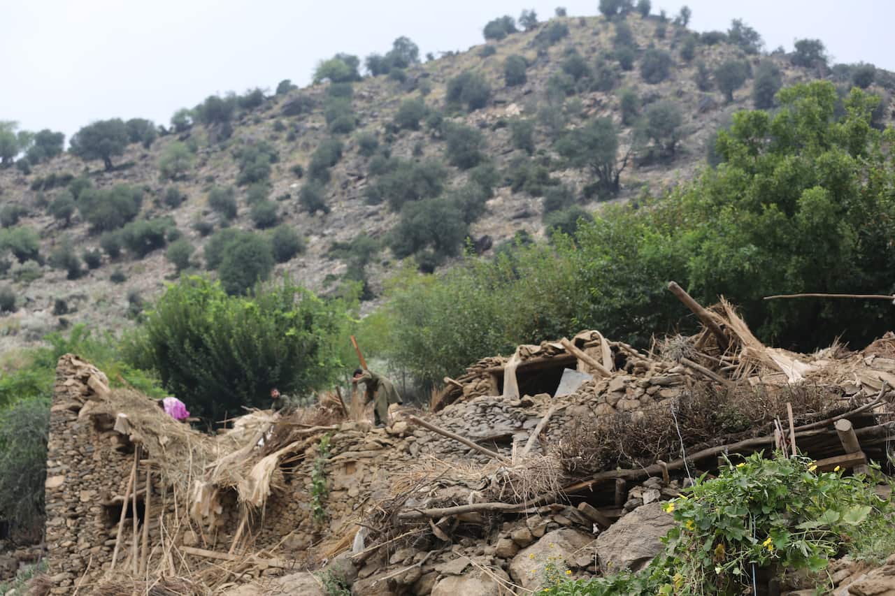 A mud brick home on a scrubby slope in ruins