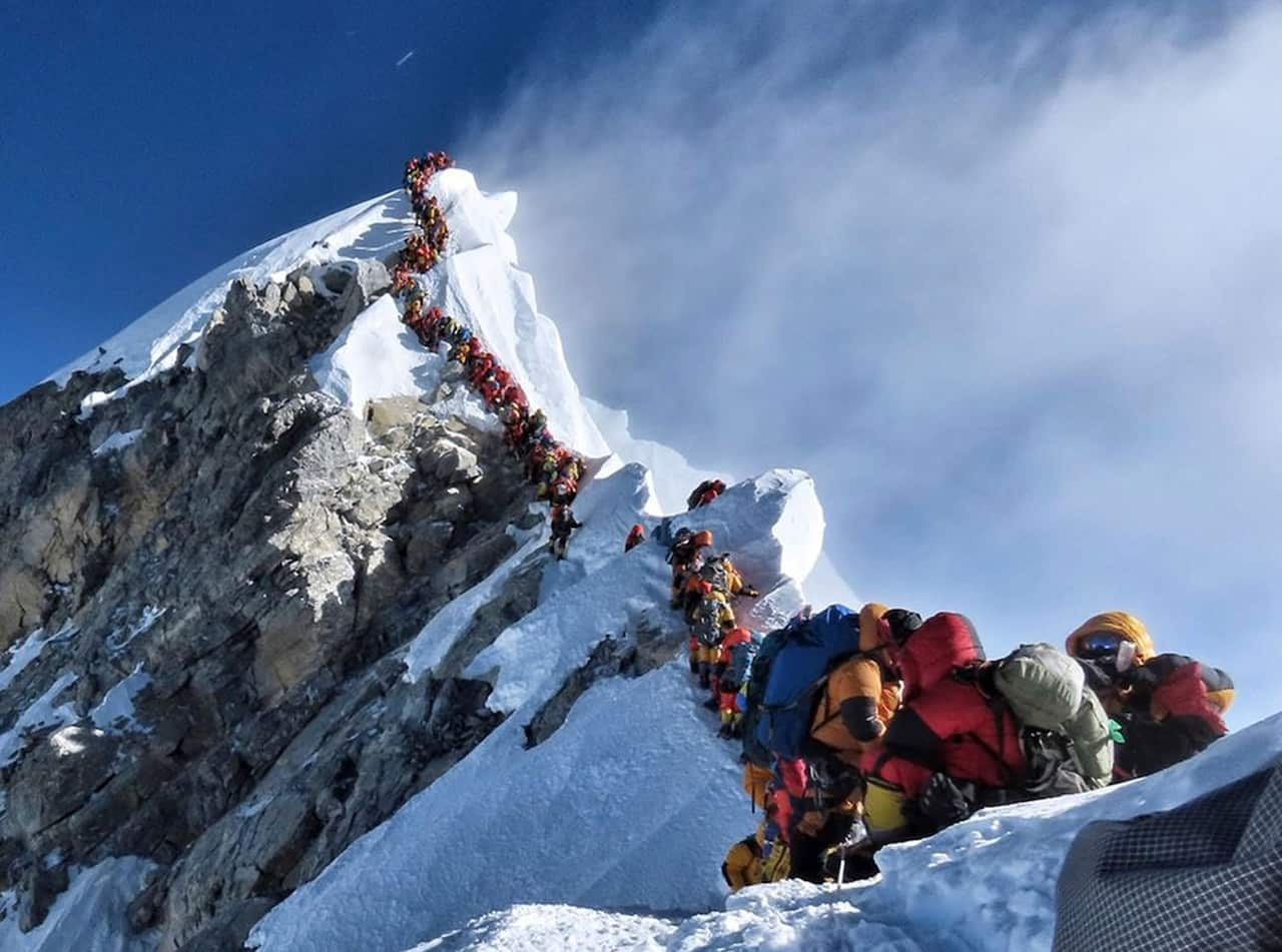 A queue of climbers on the top of Mount Everest's summit.