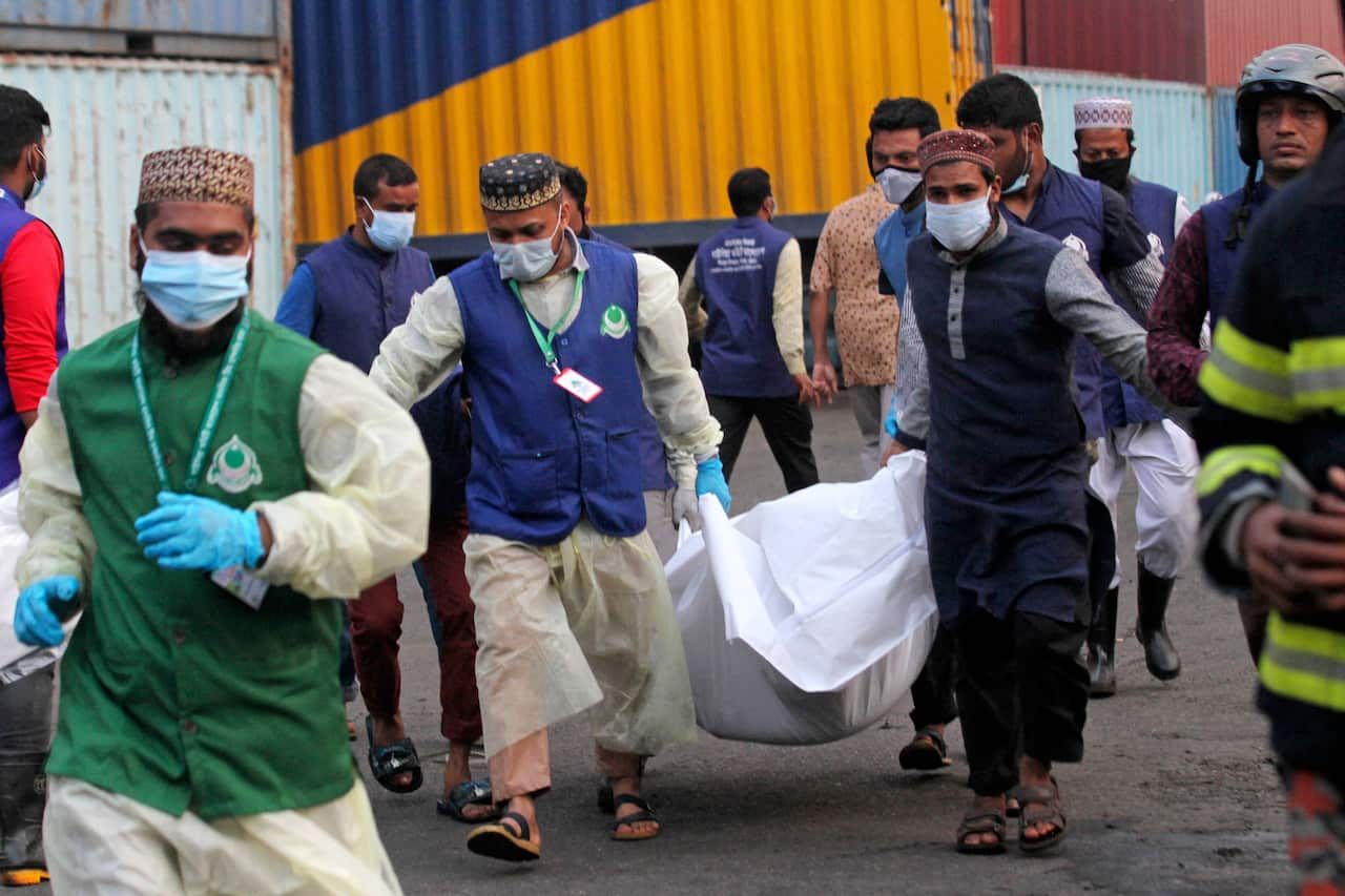 Group of people carrying a body bag