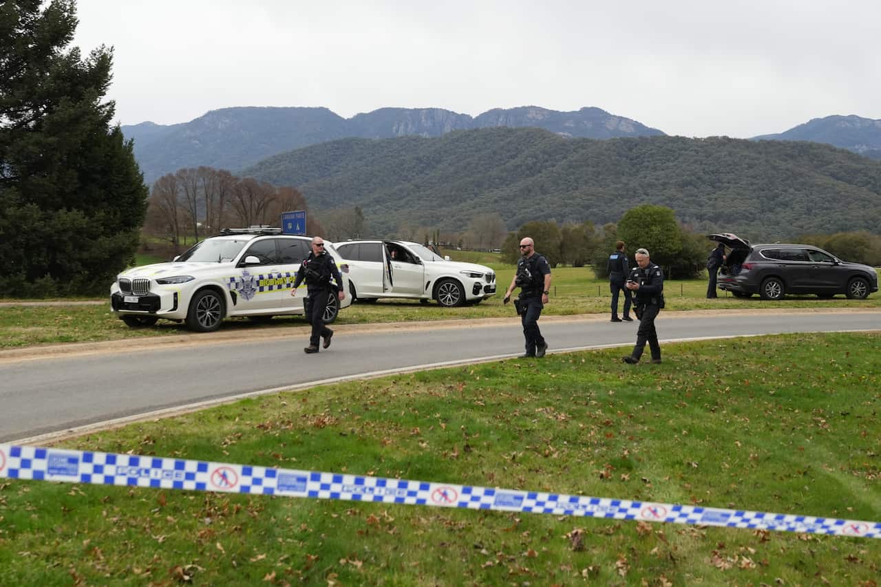 Police tape and officers around a property