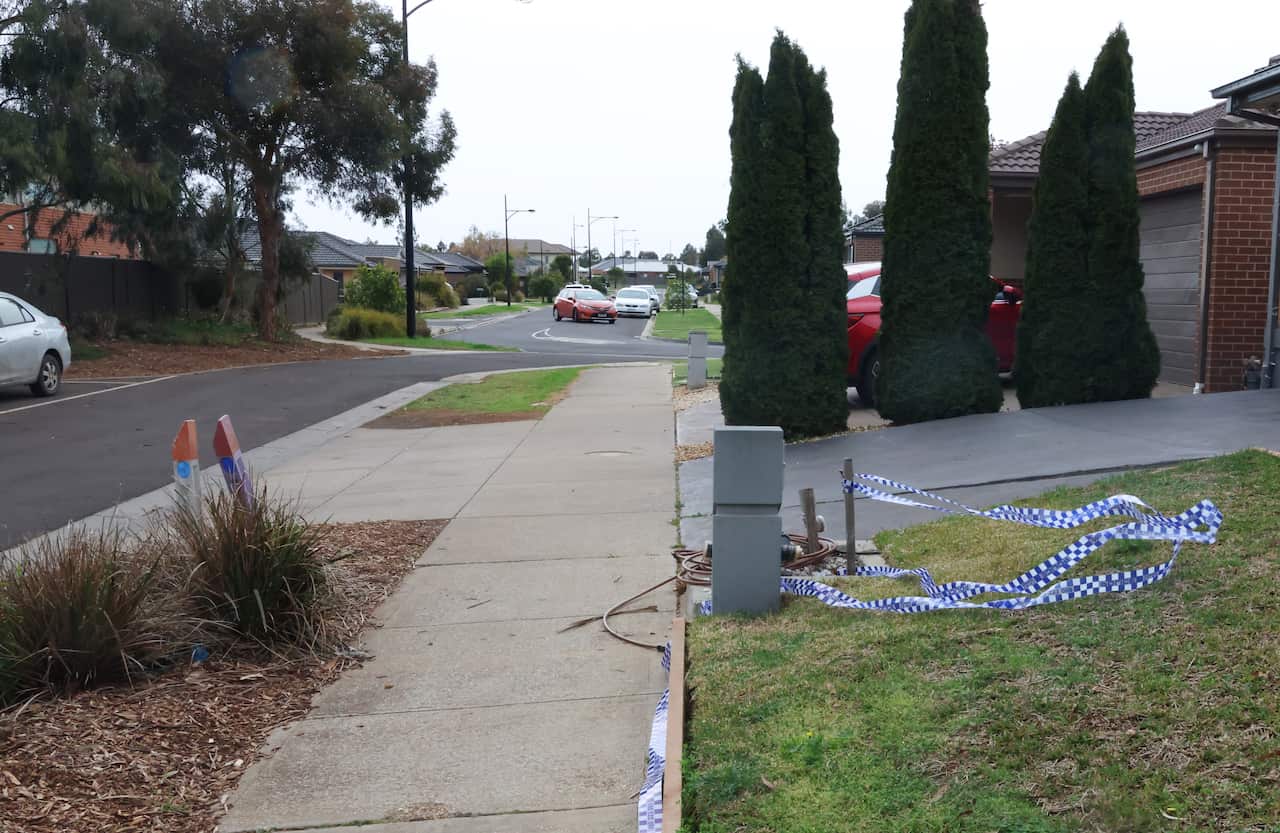Crime tape on a front lawn