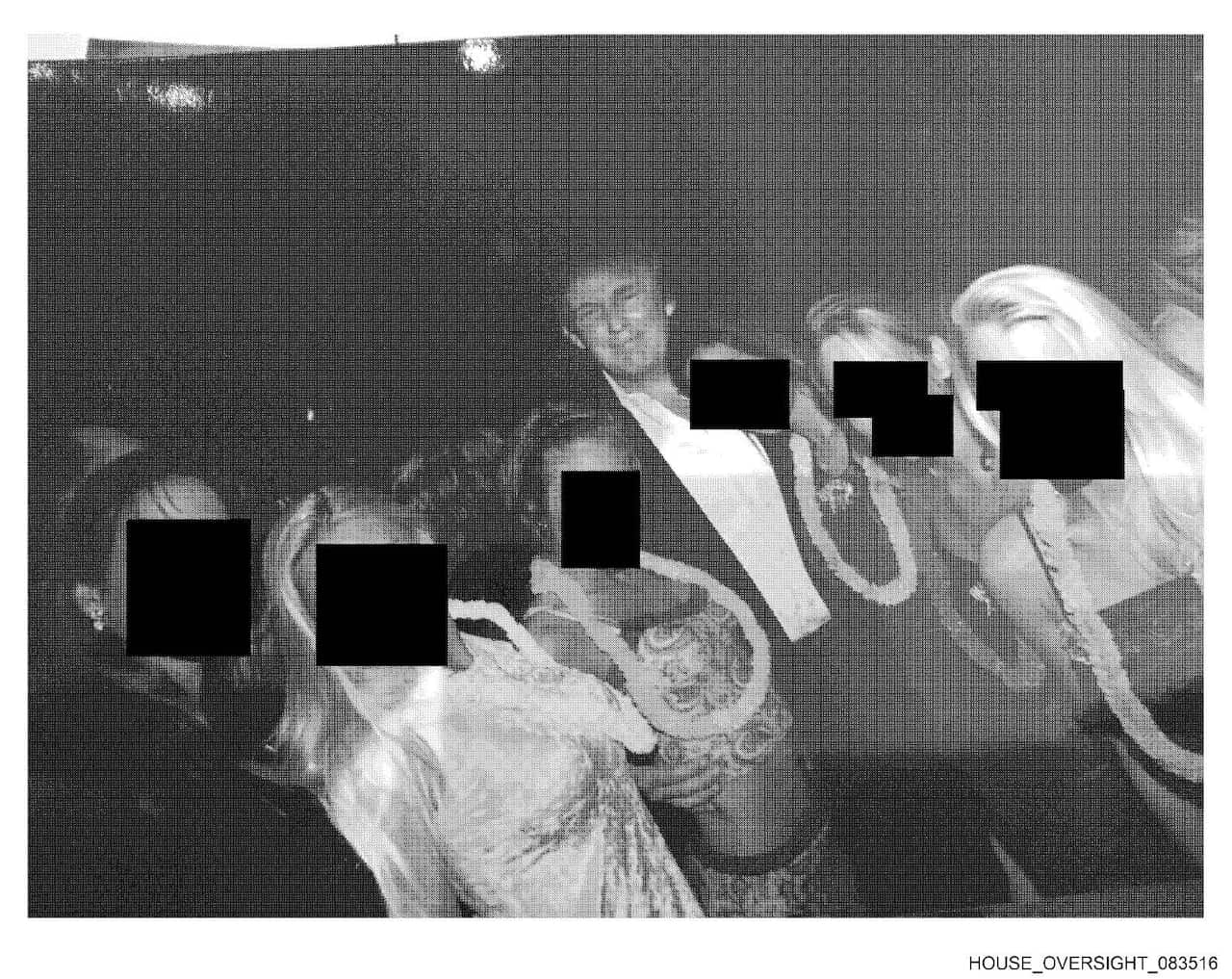 Donald Trump surrounded by women whose faces are blacked out