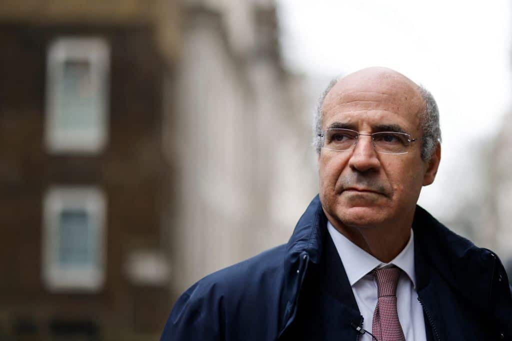 A man wearing glasses standing outside