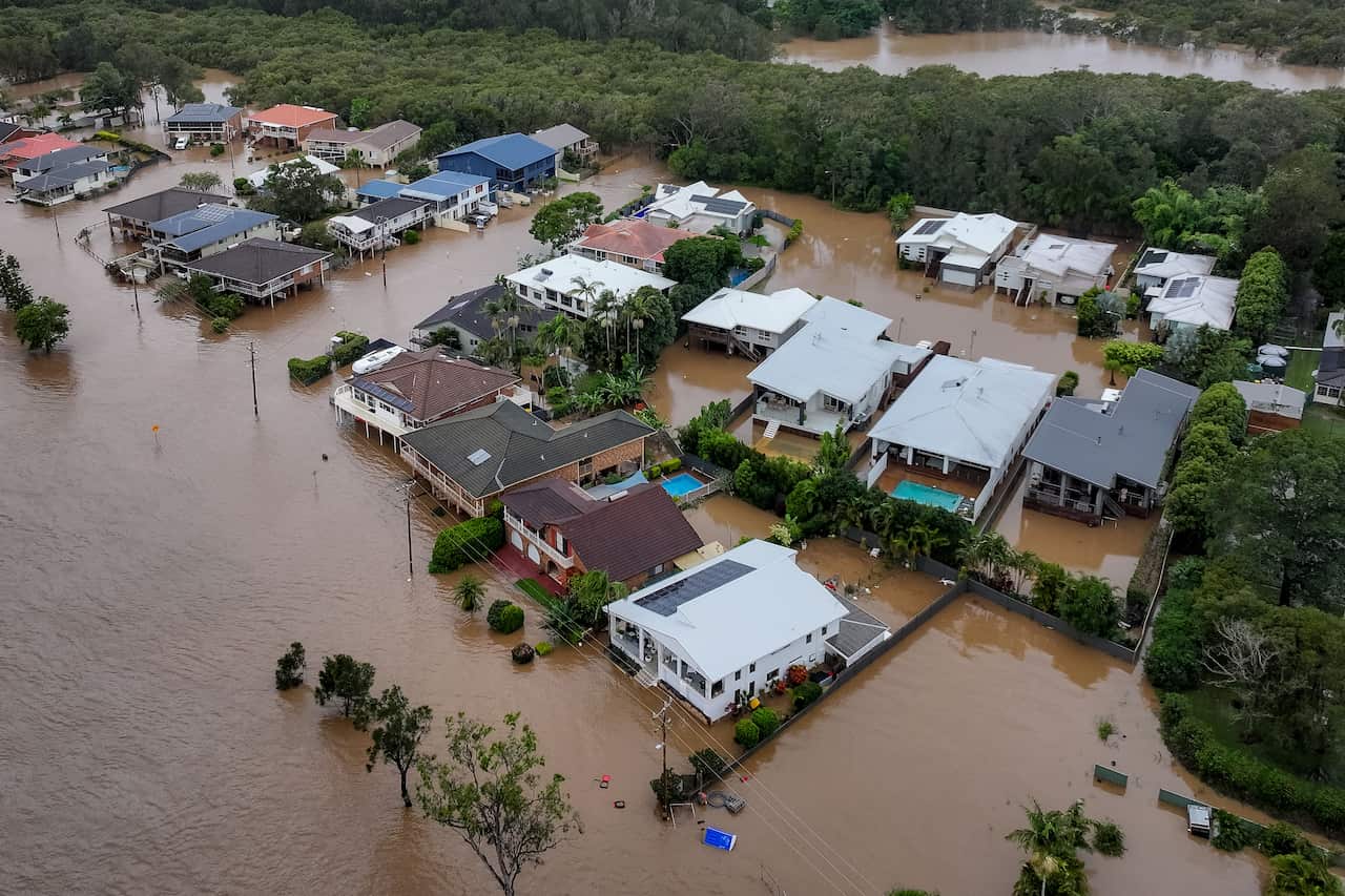 Aerial view of brown floodwaters and houses 