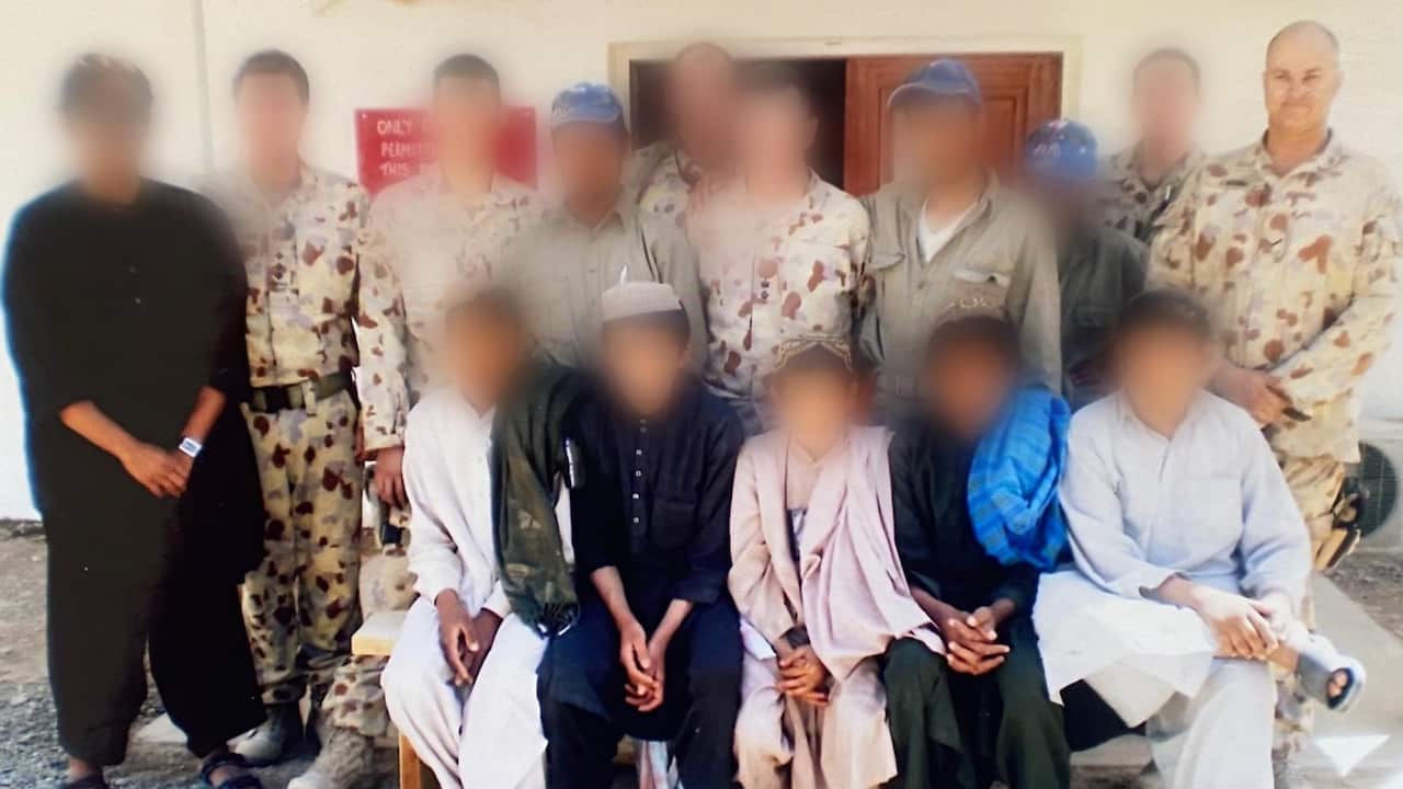 Warren and his colleagues at training school in Afghanistan. Faces of students and colleagues have been blurred.