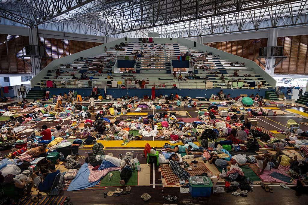 People sheltering in a basketball stadium