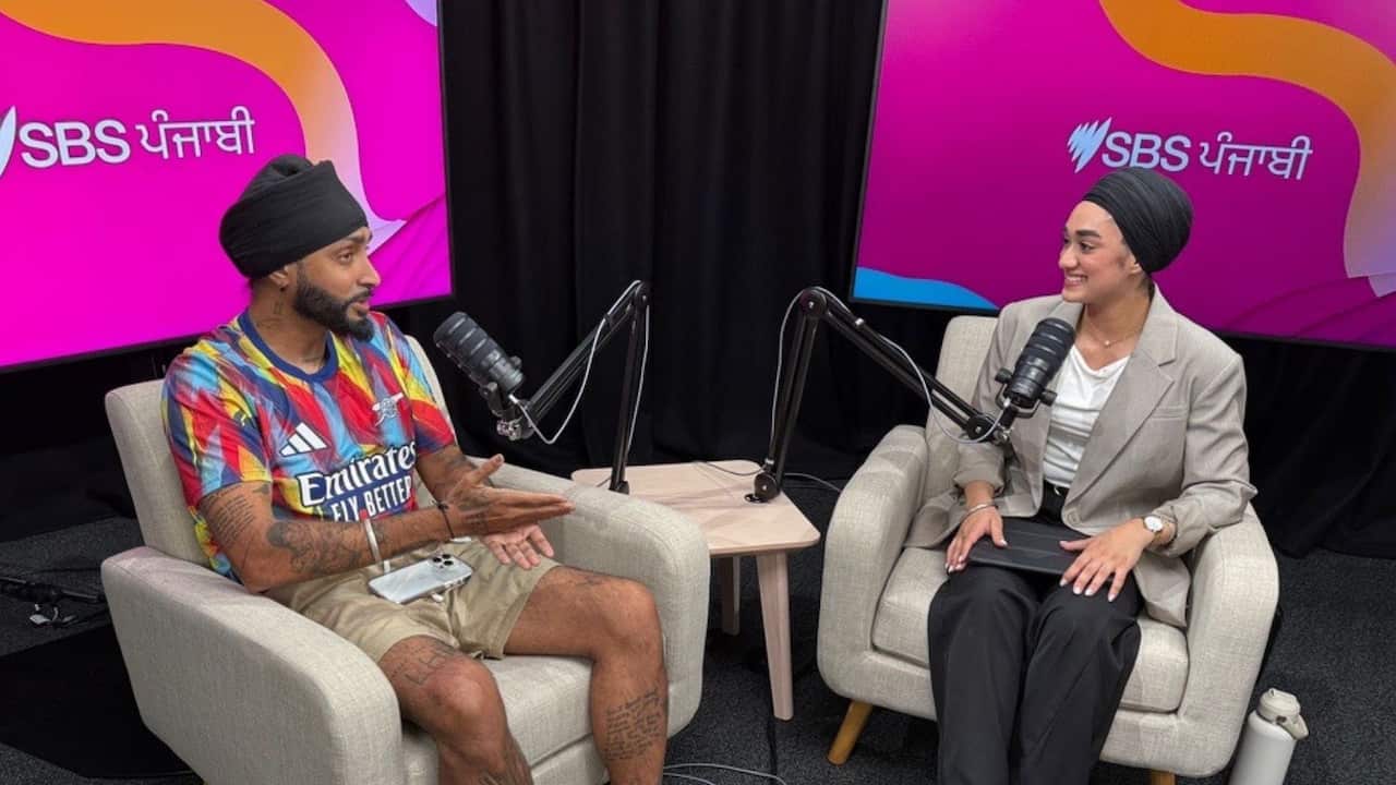 Image of UK-born Punjabi illustrator and artist Amandeep Singh at SBS Sydney headquarters, Artarmon with SBS Punjabi journalist Jasmeet Kaur. 