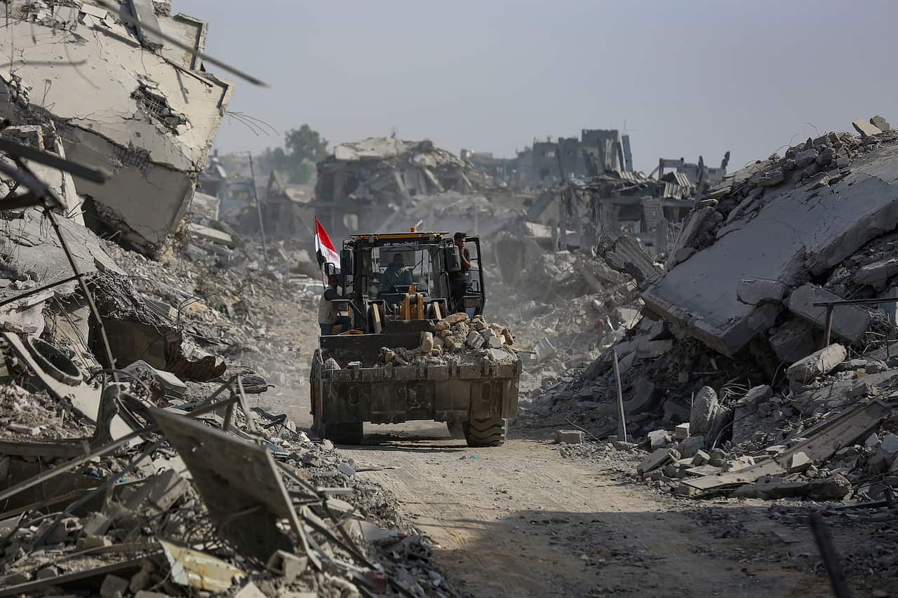 Truck drives through piles of rubble