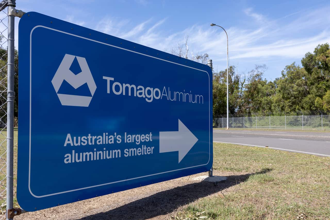 A blue sign that reads "Tomago Aluminium, Australia's largest aluminium smelter".