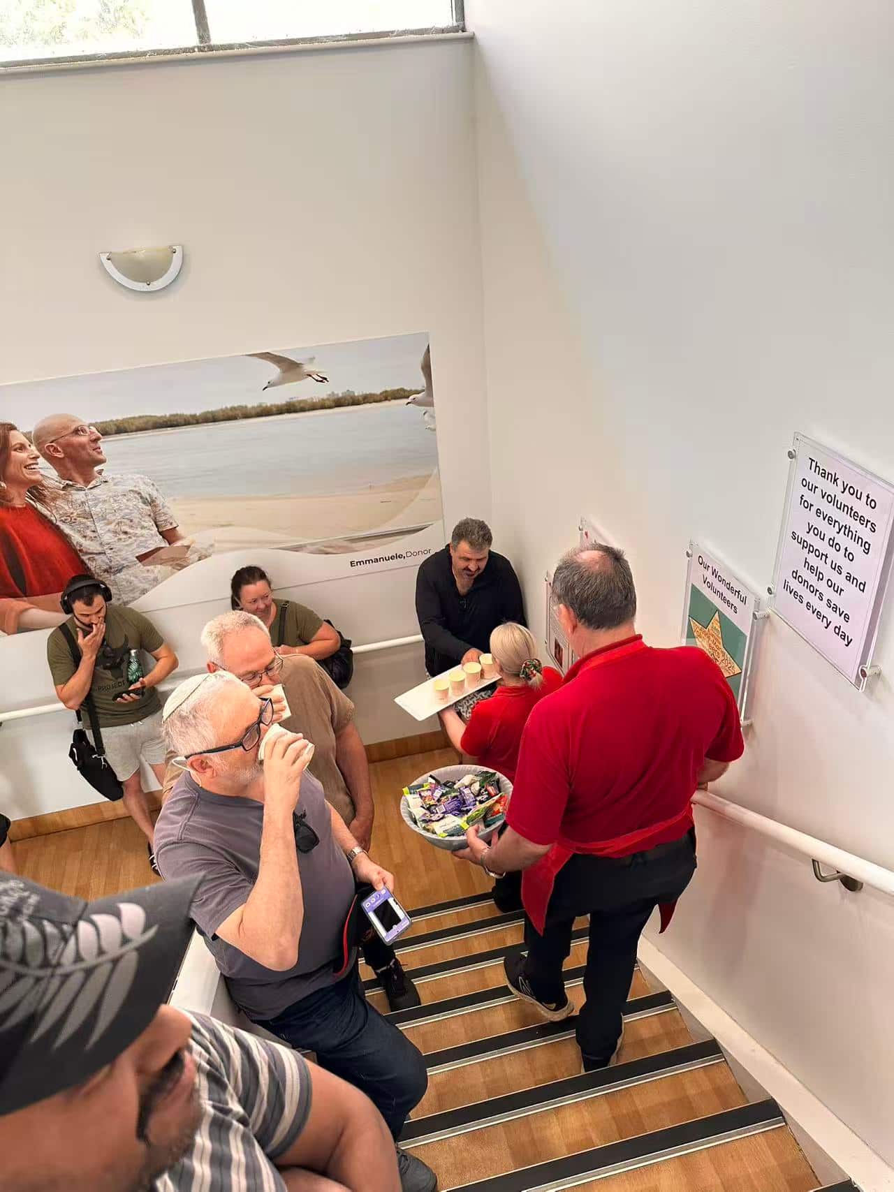 Blood donors quietly line up, waiting to donate blood.