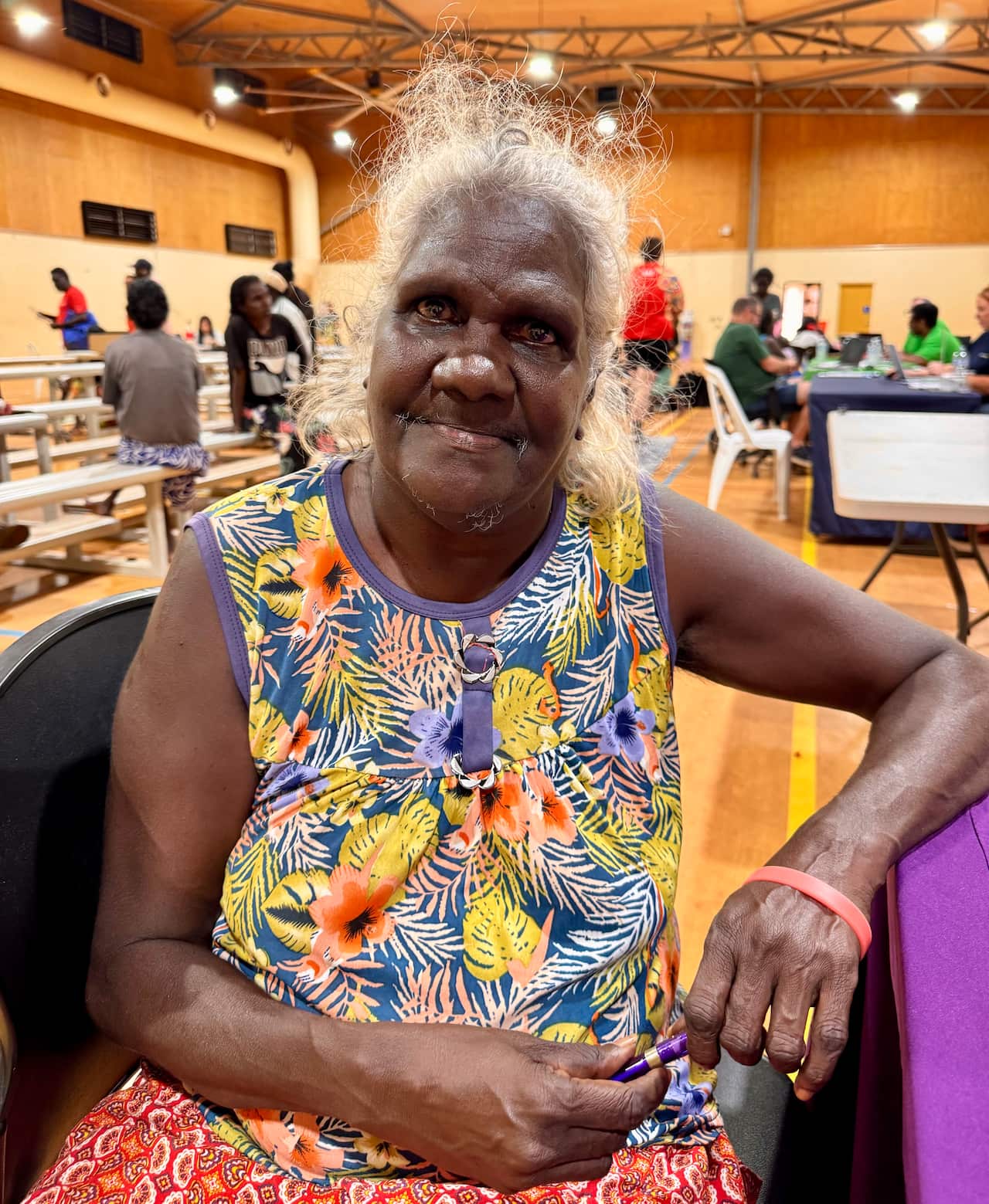 61-year-old Sandra Mamydjiwuy, wearing a bright pattern shirt sitting with financial service HESTA super fund provider