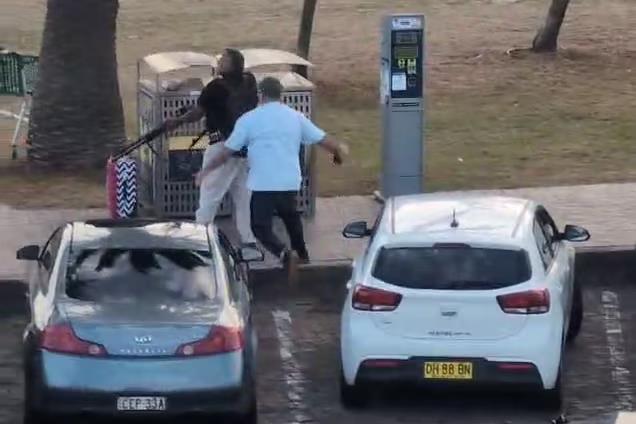 White streaks in night sky above an observatory.