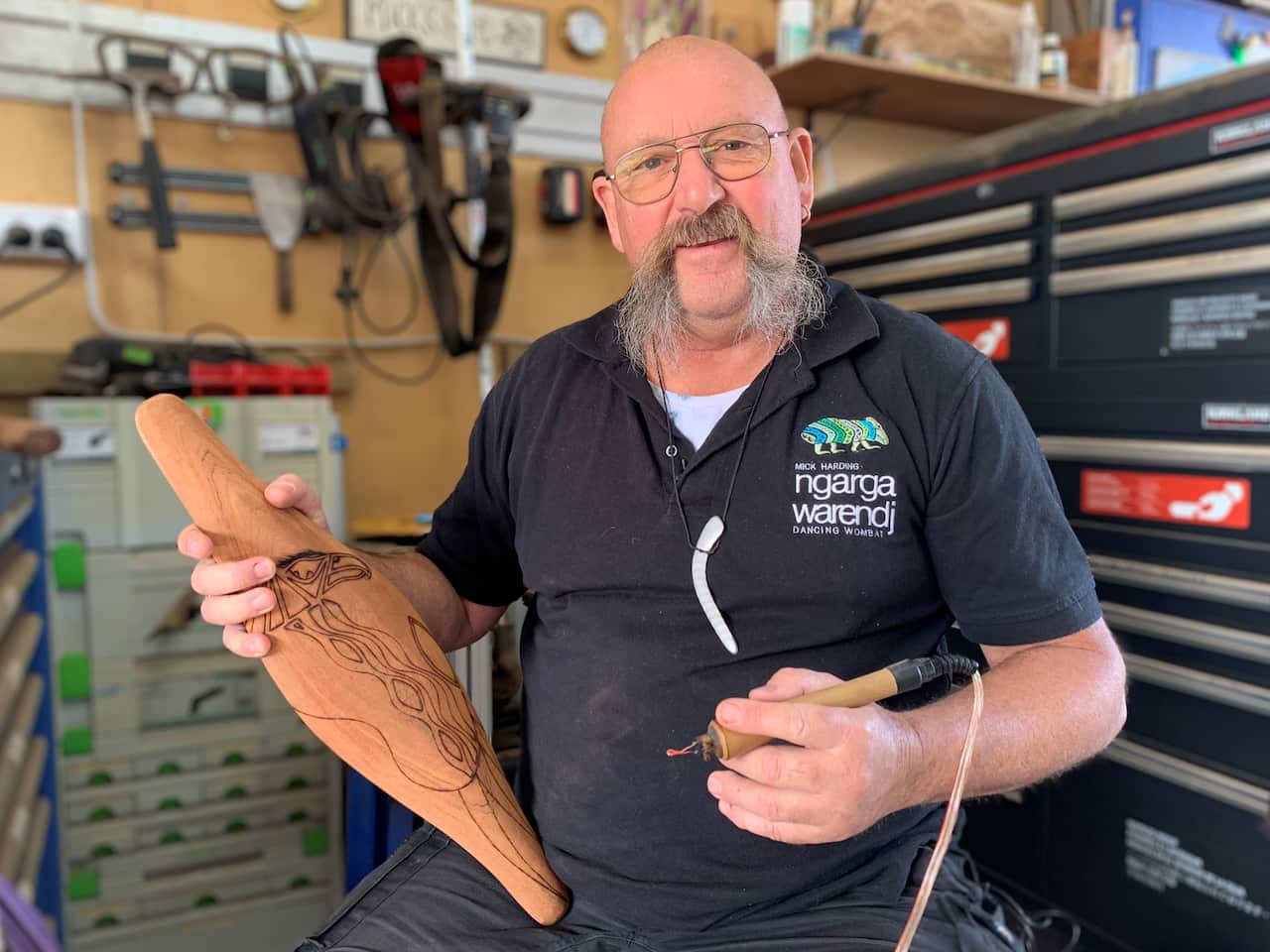 Mick burns traditional symbols into wood 