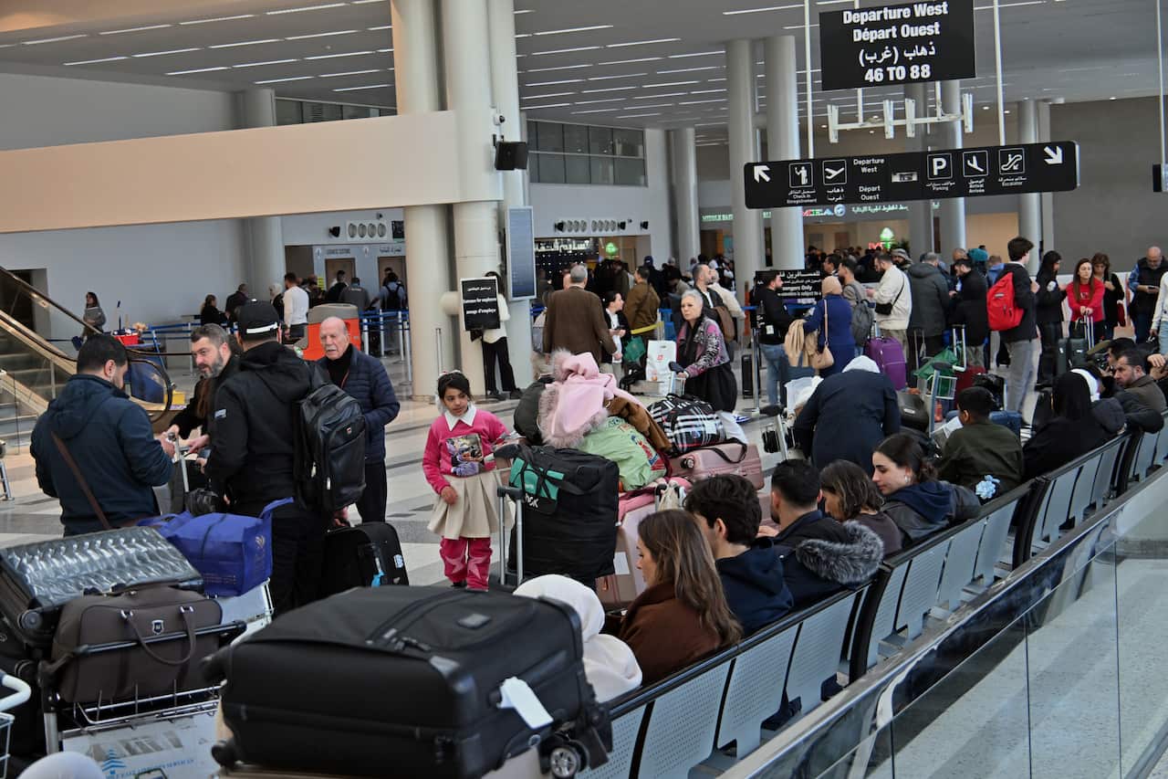 Passengers inside an airport terminal.