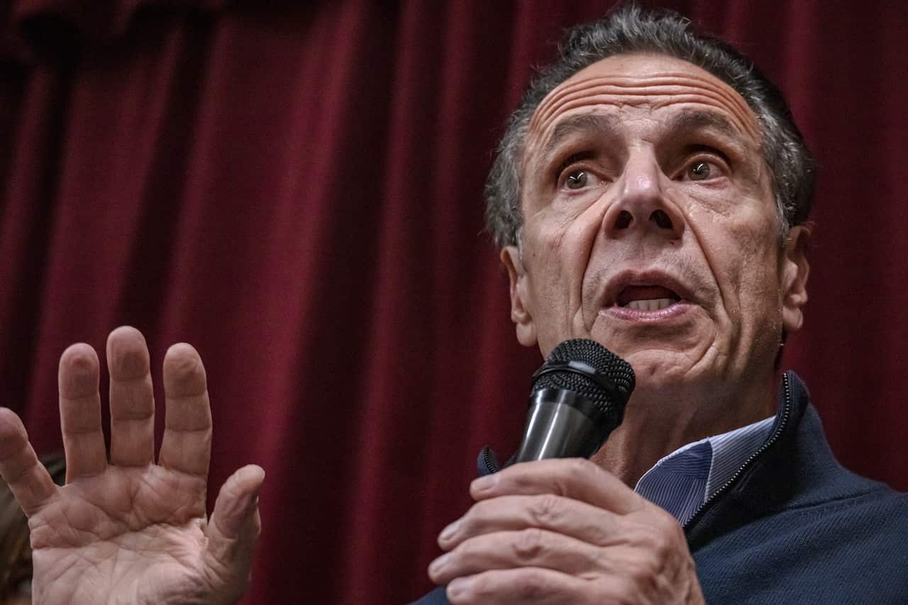 A man speaking into a handheld microphone