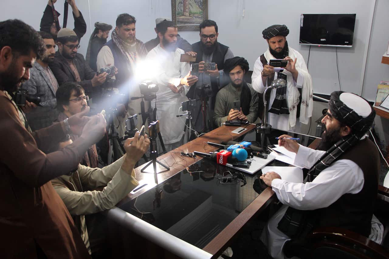 A man talking to reporters