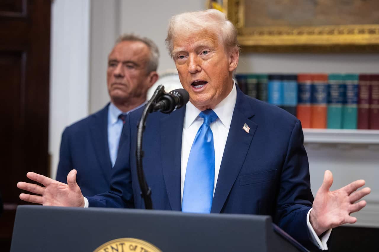 A man in a suit addressing a press conference