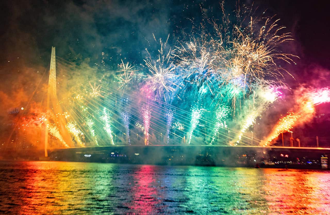 Rainbow fireworks over a bridge