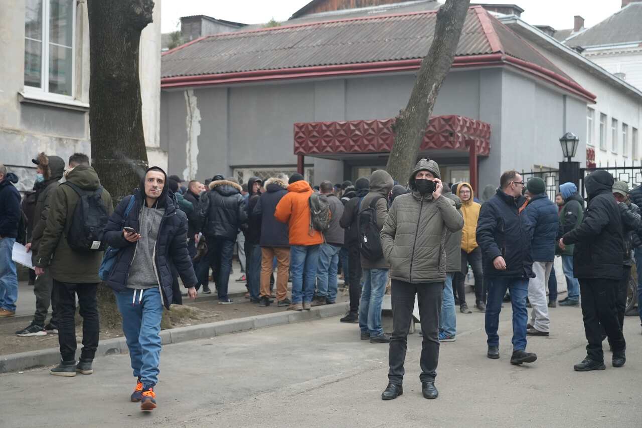 Dozens of people standing in line at the conscript office in Lviv