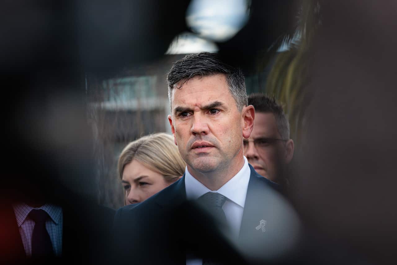 A man in a suit is frowning.