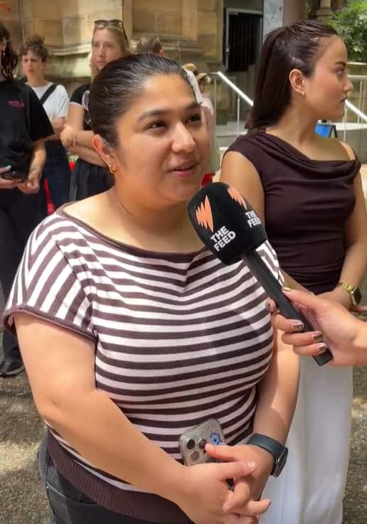 A woman wearing a striped shirt being interviewed.