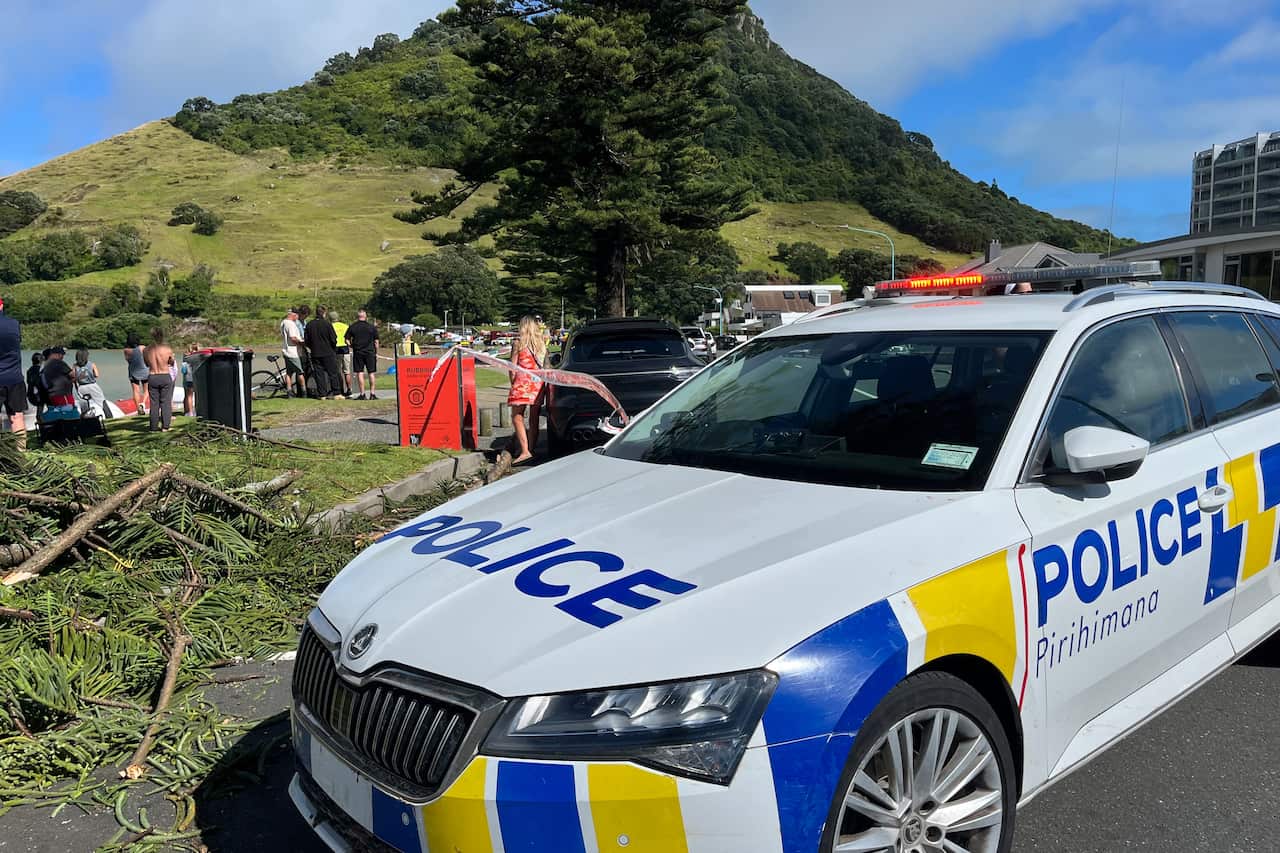 A police car is stopped in front of a campsite.