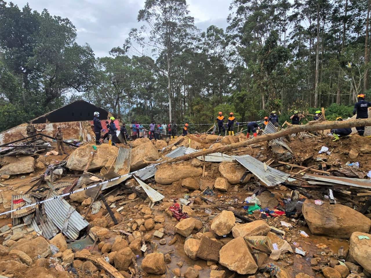 Rocks and mud along a destroyed road in a mountain area.