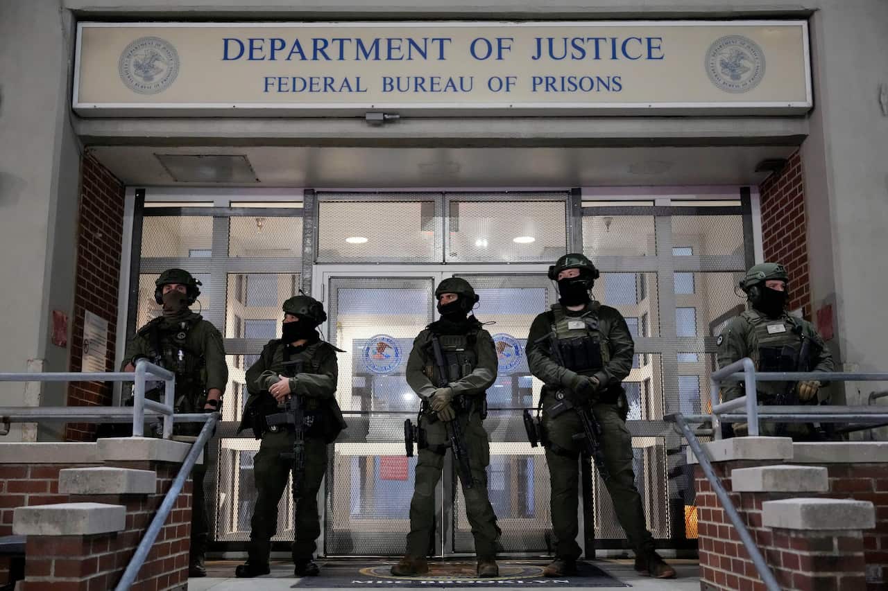 A group of heavily armed military personnel standing outside a building