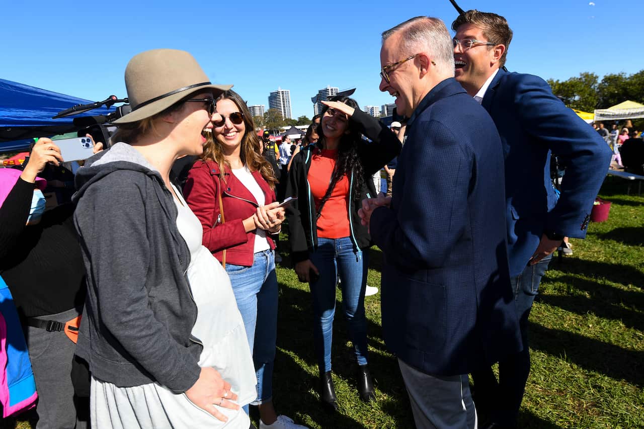 Australian Opposition Leader Anthony Albanese and Labor candidate for the seat of Bennelong Jerome Laxale talk to local residents during a visit to Ryde Wharf Market on Day 28 of the 2022 federal election campaign, in Sydney, Sunday, May 8, 2022. 