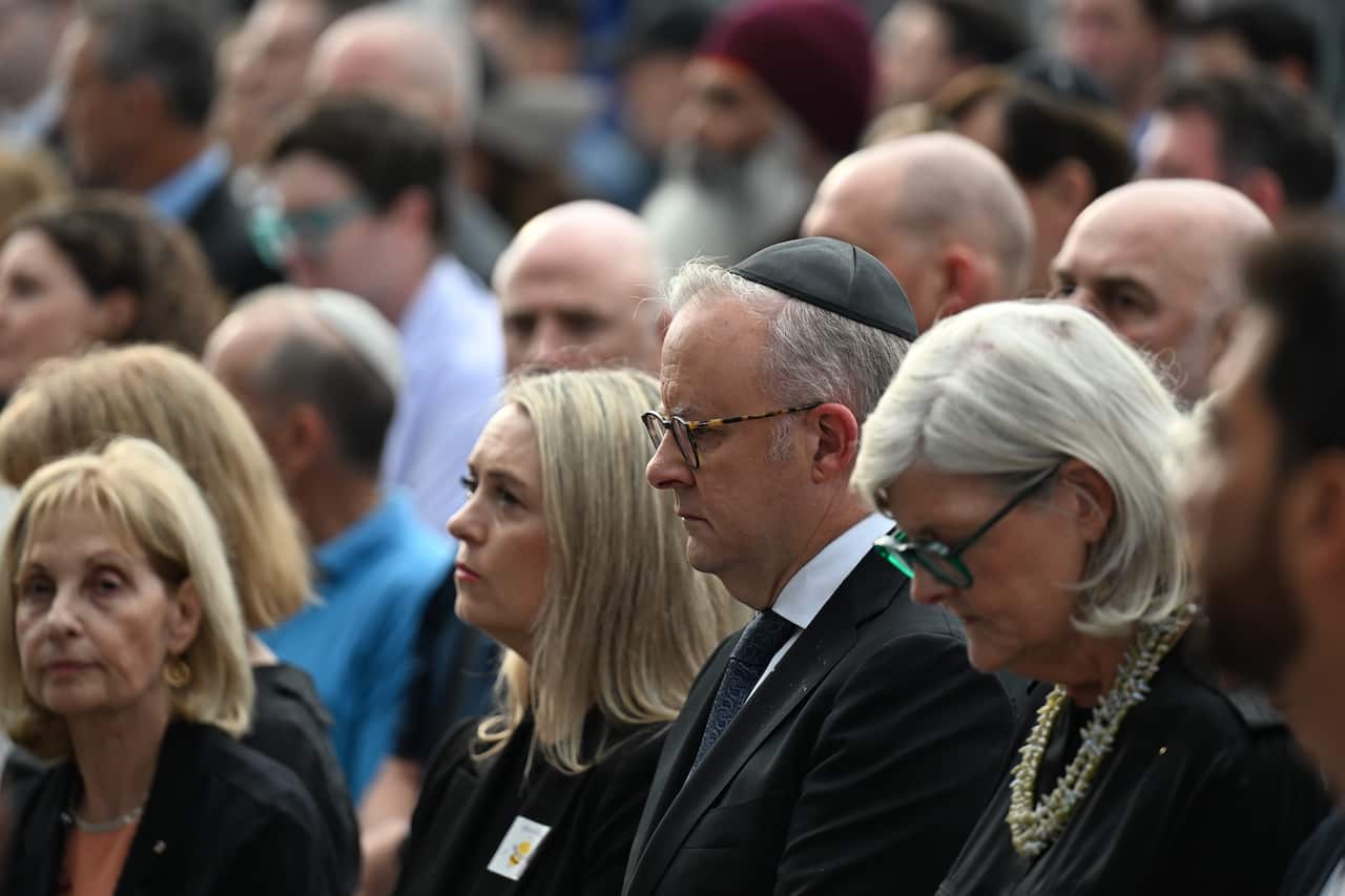 Anthony Albanese is standing in a crowd wearing a kippah.