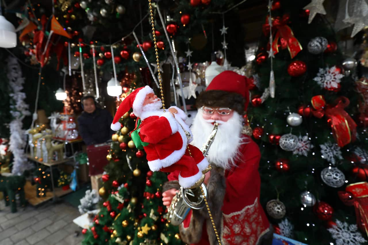 A Santa Claus toy and a Christmas tree