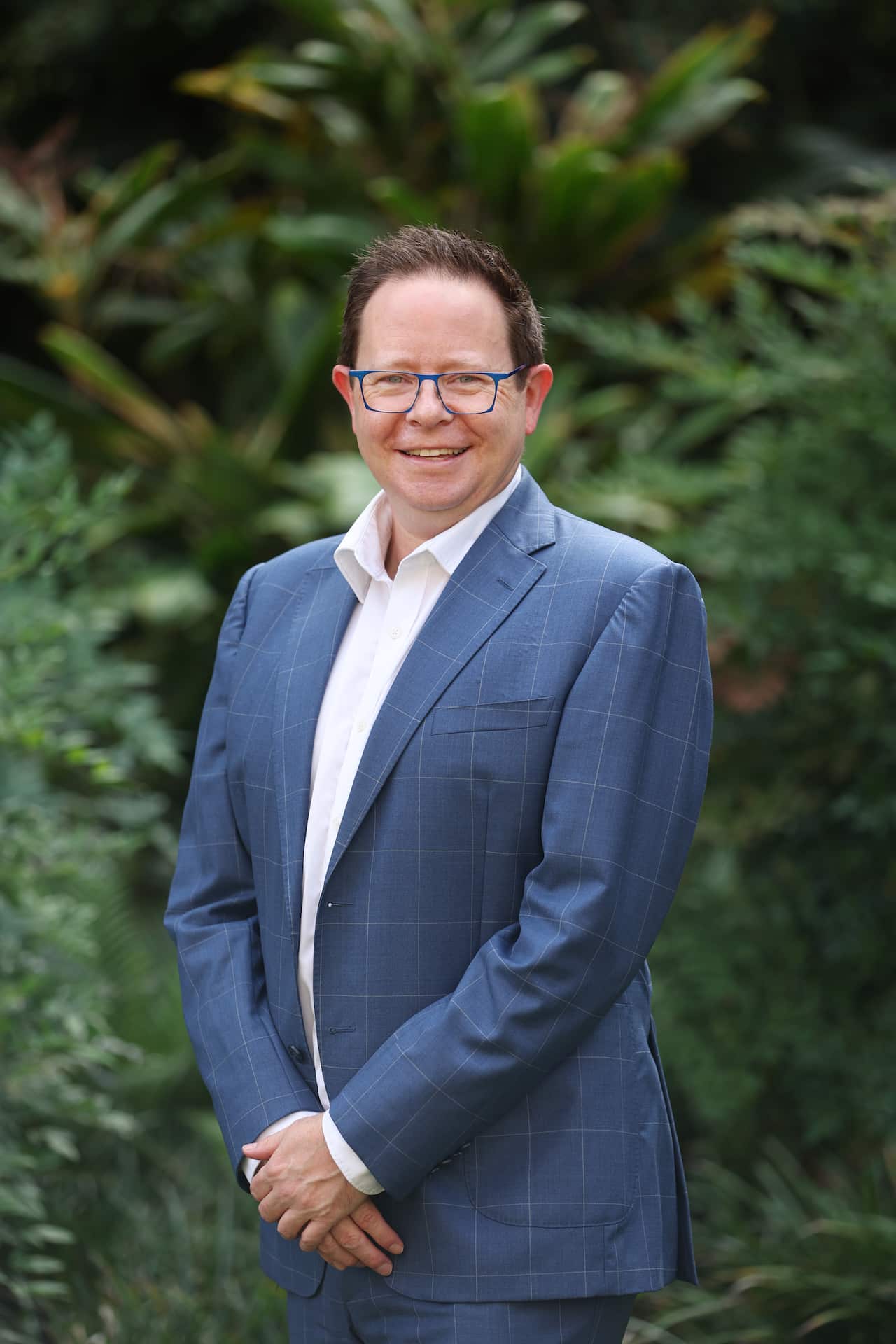 A smiling man in a blue suit.