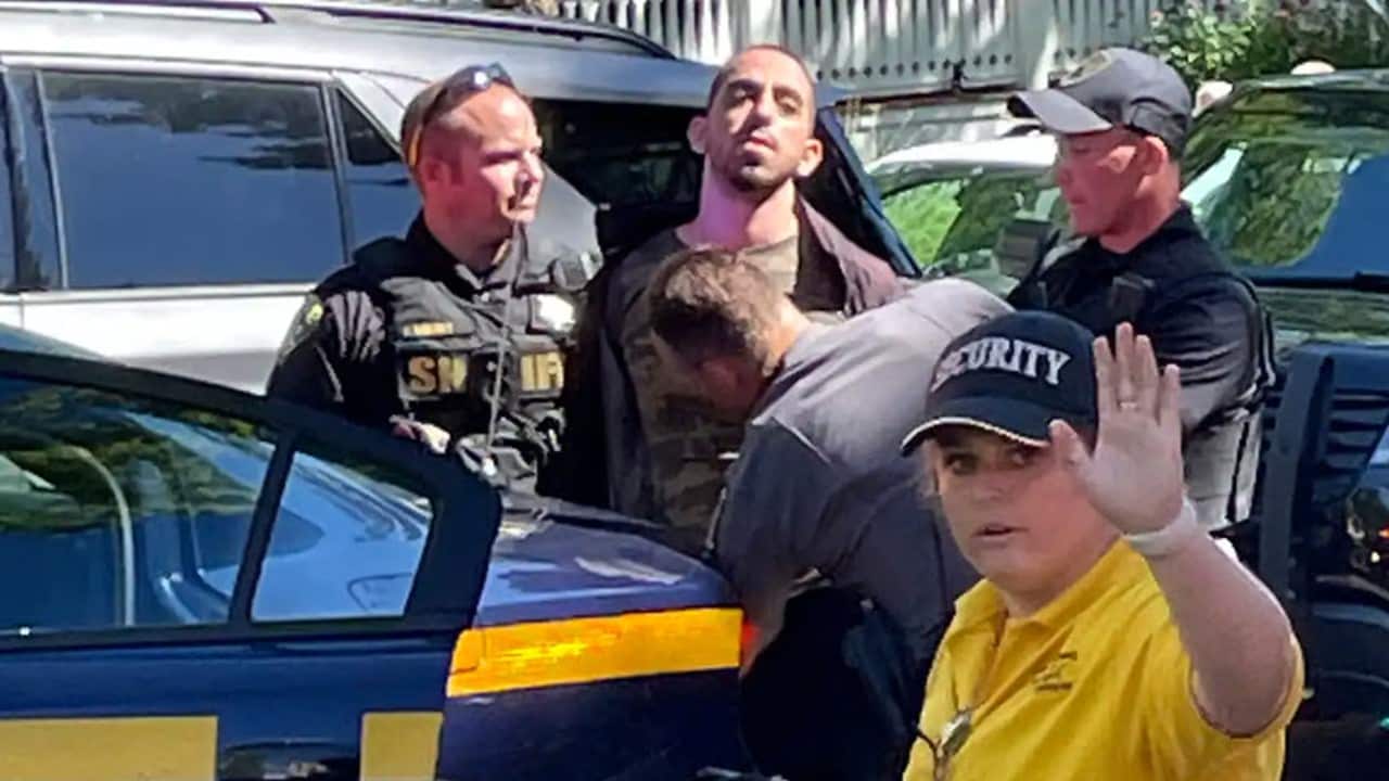 Law enforcement officers detain a person outside the Chautauqua Institution.jpg