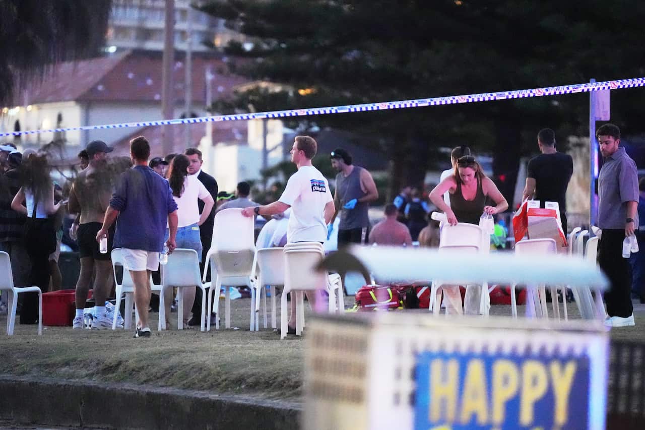 People and plastic chairs on a grass area