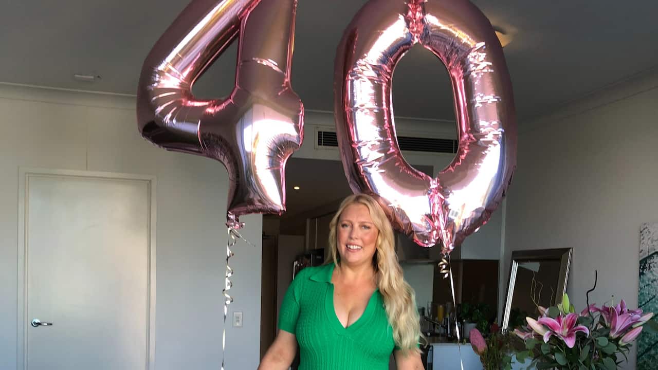 Mel Greig holding baloons on her 40th birthday.