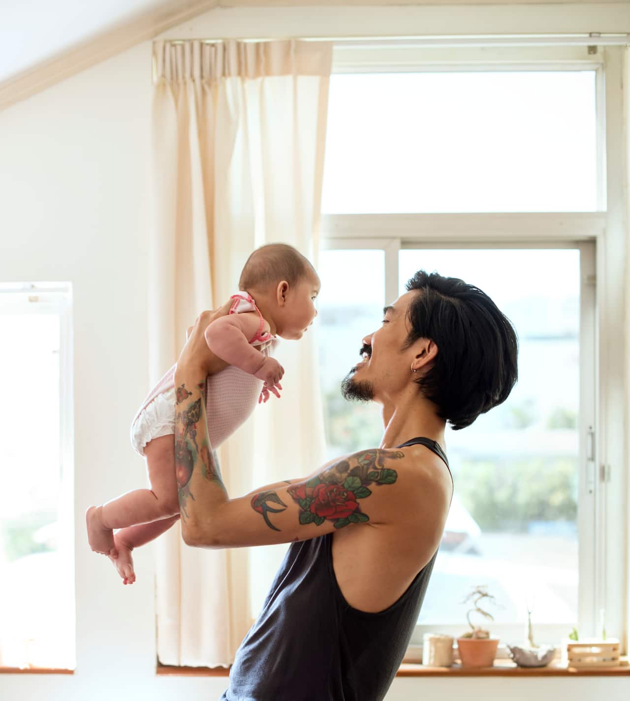 asian-dad-holding-his-baby-up-with-love.jpg