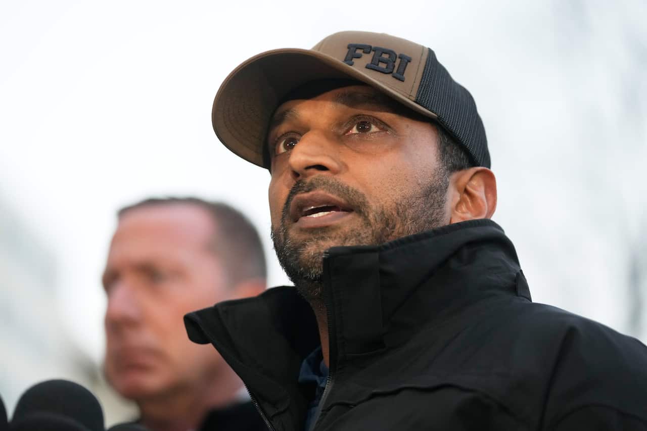 Kash Patel, wearing a black jacket and a hat that says "FBI".