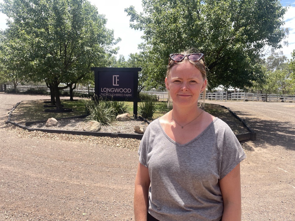 A young white woman standing in a drive way