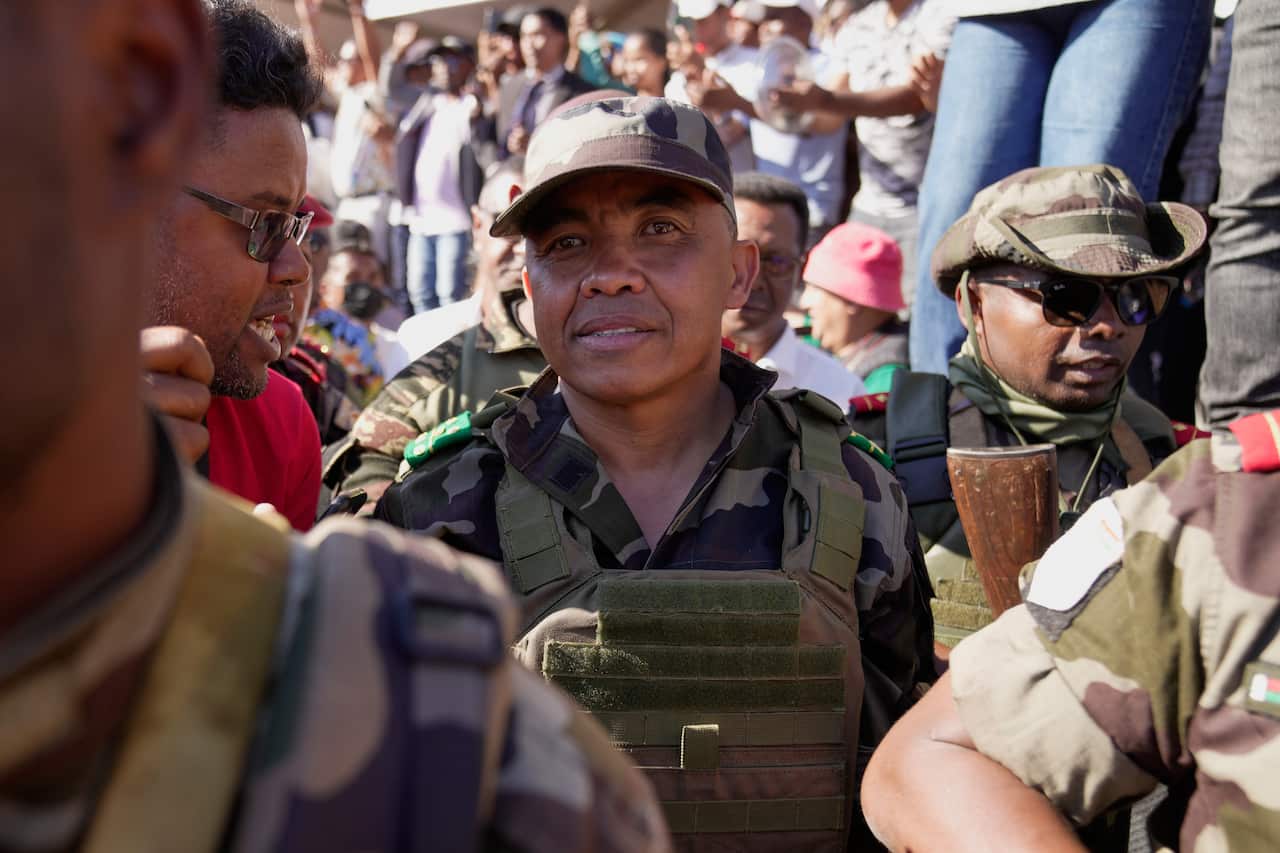 A man wearing a military uniform among a crowd of people.